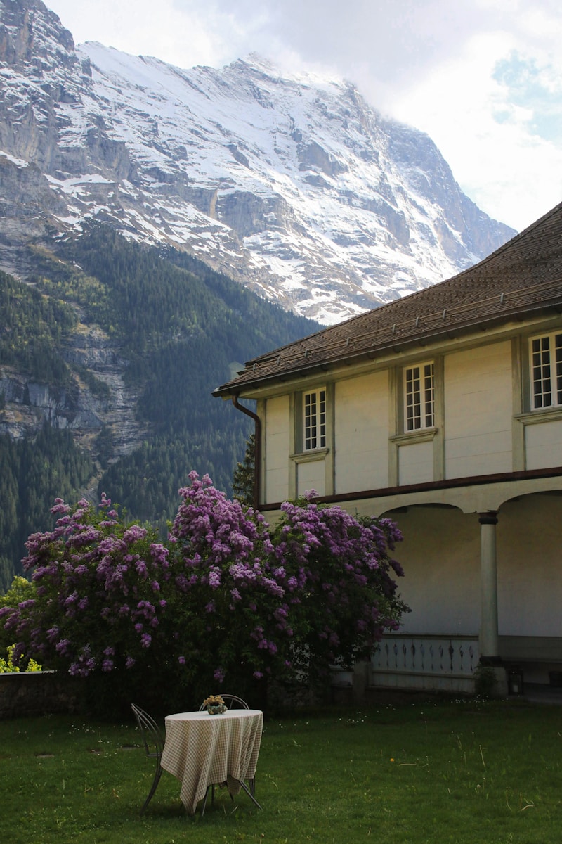 Photo by Isaac Quick A table sits before mountains and a house.